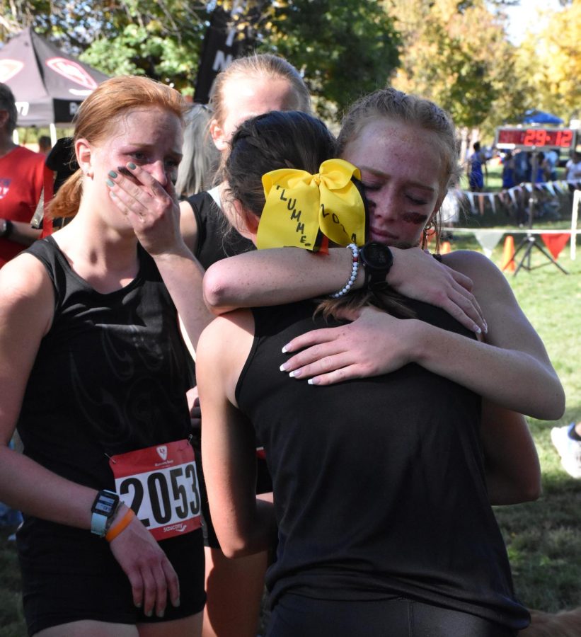 Brenna Wendell (far left) watches as Mari Boekes (facing camera) hugs Reese Plummer after the regional race. Both girls were feeling disappointed. I think at that time she needed to hear someone say she was proud of her, Boekes said.